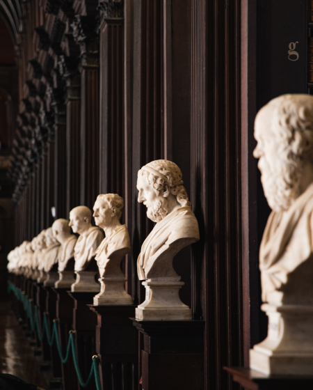 A row of plaster busts along the wall