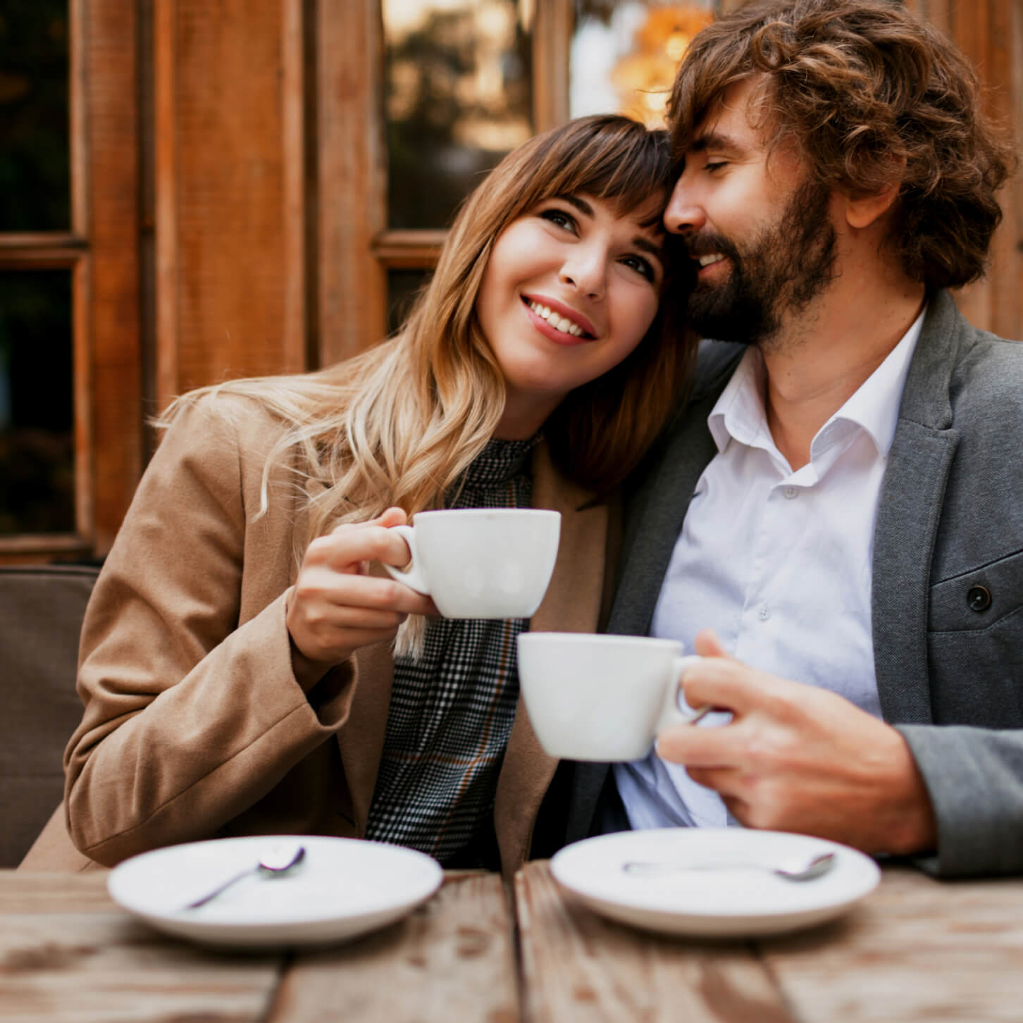 Young couple sitting in the cafe and having their coffee