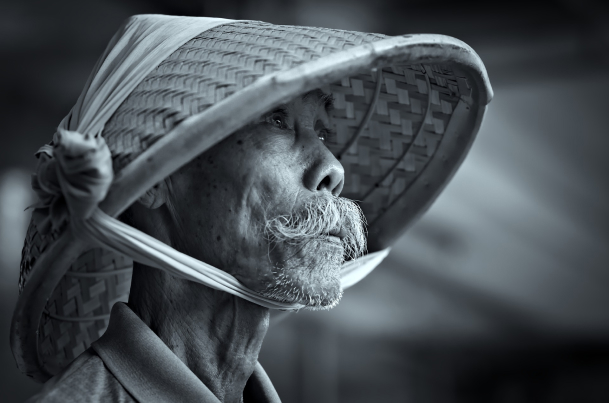 a man with bamboo cap